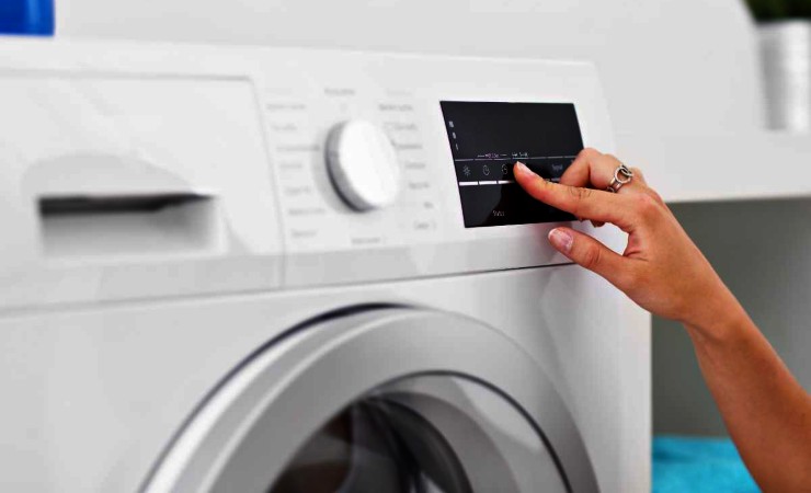 mano che imposta lavatrice